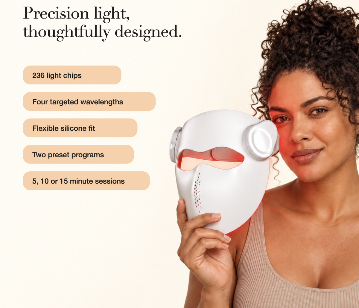 Woman holding the white Kivorla laser mask next to her face