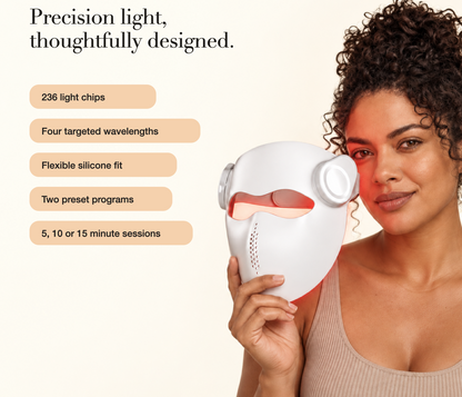Woman holding the white Kivorla laser mask next to her face
